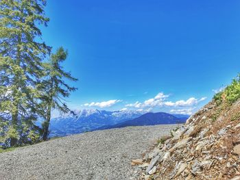 Scenic view of mountains against blue sky