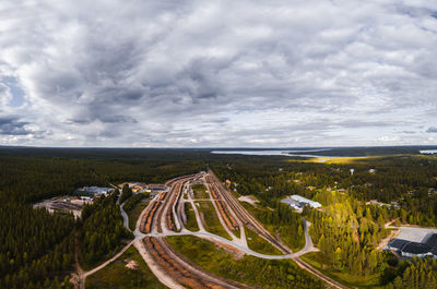 Panoramic shot of road amidst field against sky