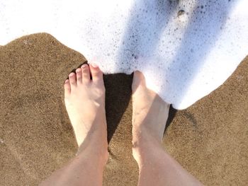 Low section of woman at sea shore