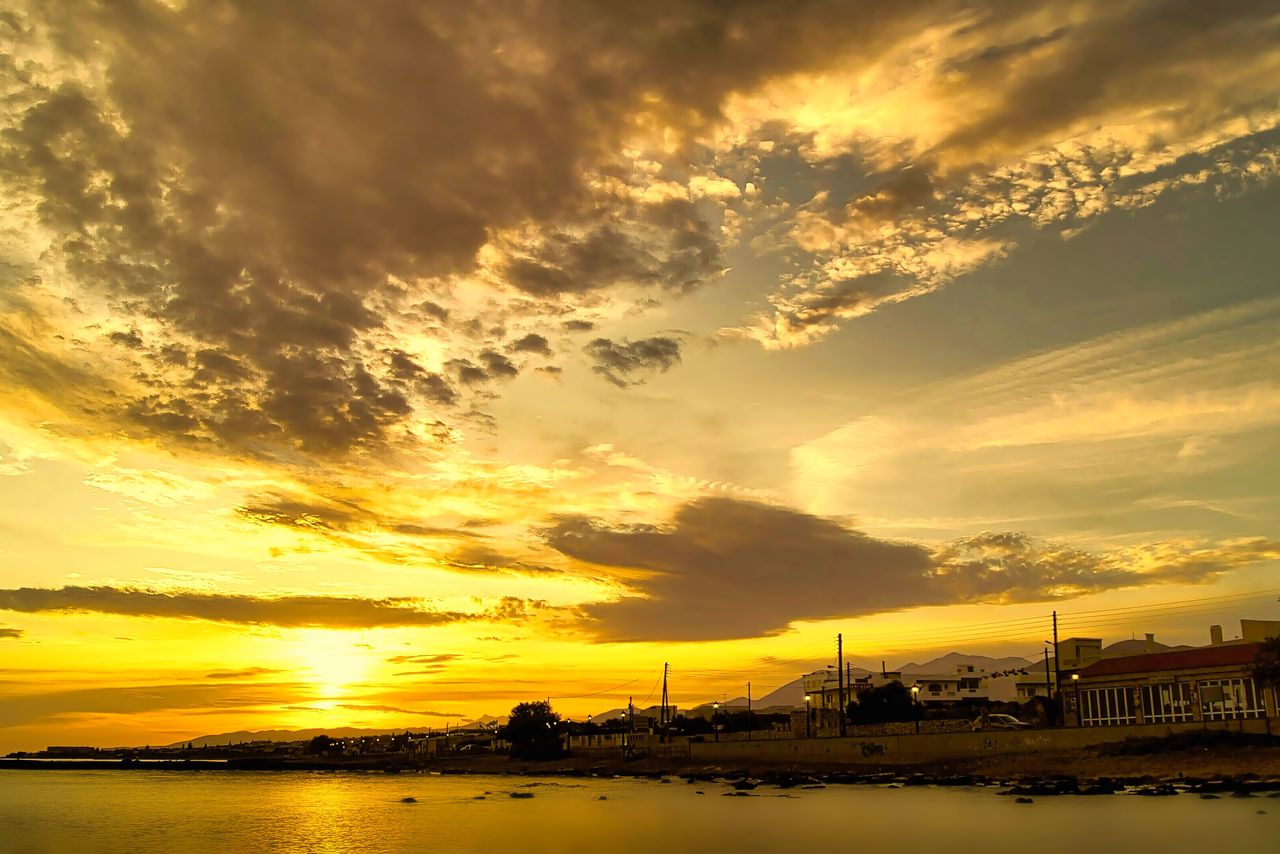 sky, sunset, cloud, water, afterglow, beauty in nature, nature, scenics - nature, dramatic sky, sea, sun, reflection, environment, architecture, horizon, dawn, tranquility, orange color, sunlight, landscape, travel destinations, evening, no people, cloudscape, tranquil scene, red sky at morning, outdoors, yellow, built structure, transportation, city, travel, idyllic, nautical vessel, beach, silhouette, land, multi colored, gold, tourism, moody sky