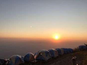 Scenic view of land against clear sky during sunset