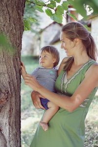 Mother and daughter on tree trunk