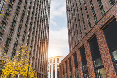 Modern residential complex skyscrapers front view and sun beam