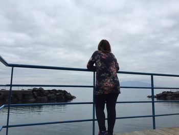 Silhouette of man standing against cloudy sky