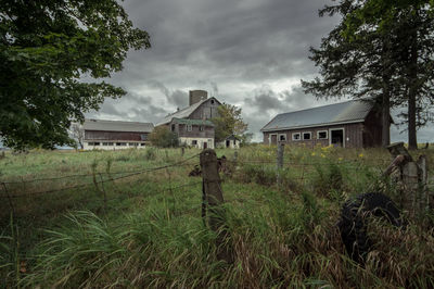 Houses on field against sky