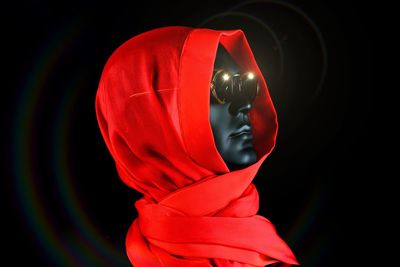 Close-up of red statue against black background