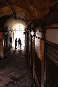 Rear view of people walking in building