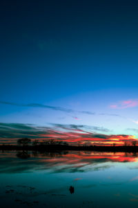 Scenic view of lake against blue sky