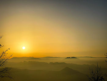 Scenic view of silhouette mountains against sky during sunset