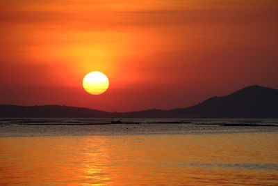 Scenic view of sea against romantic sky at sunset