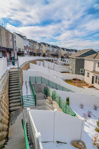 High angle view of houses in town against sky