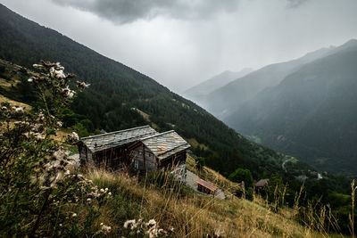 Scenic view of mountains and houses against sky