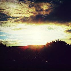 Scenic view of landscape against sky at sunset