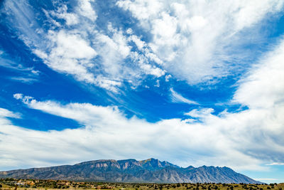 Low angle view of mountain against blue sky