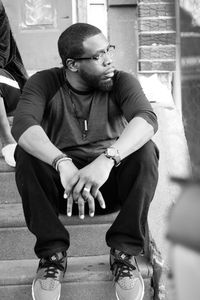 Midsection of man sitting on floor