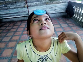 Girl spinning fidget spinner on forehead