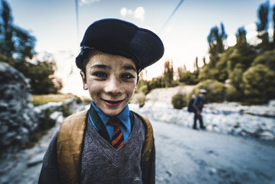 Portrait of smiling boy standing outdoors