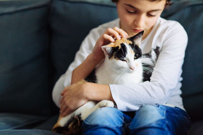Midsection of boy with cat