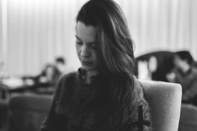 Portrait of a young woman sitting at home