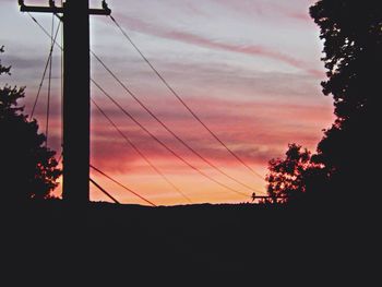 Low angle view of silhouette trees against sky at sunset