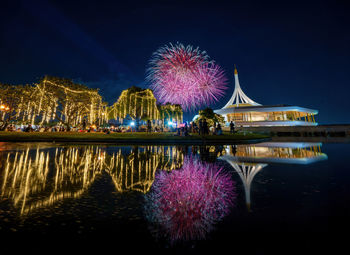Low angle view of firework display at night
