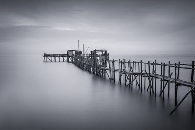 Pier over sea against sky