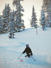 Woman standing on snow covered landscape