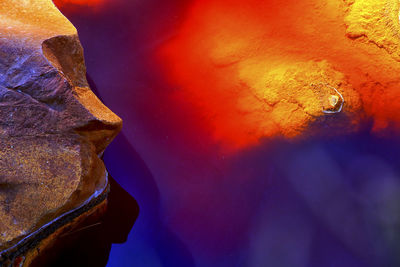 Close-up of water on rock against sky at night