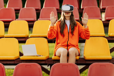 A young athlete wearing virtual reality glasses, dressed in sportswear