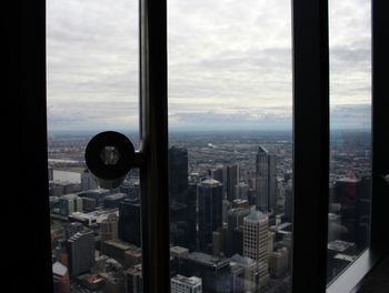 View of cityscape against cloudy sky