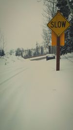 Road sign against sky