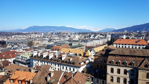 High angle view of town against blue sky