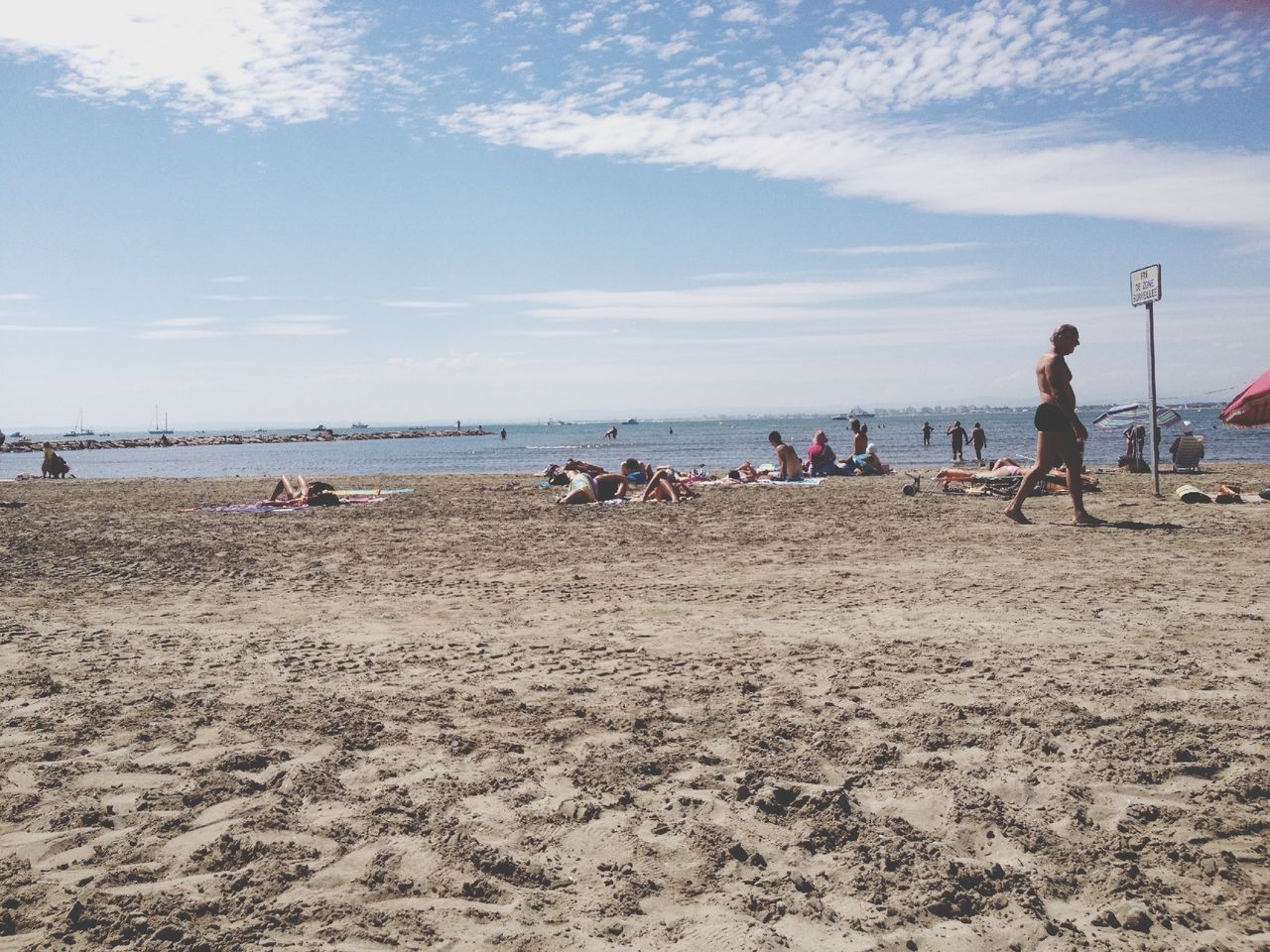 beach, sea, water, sky, lifestyles, leisure activity, shore, sand, large group of people, vacations, men, horizon over water, person, scenics, cloud - sky, mixed age range, enjoyment, nature, togetherness