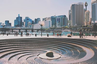 People by spiral fountain at darling harbor in city