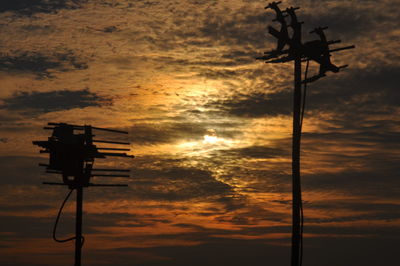 Low angle view of silhouette pole against sky during sunset