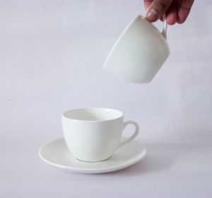 Hand of person pouring coffee in cup