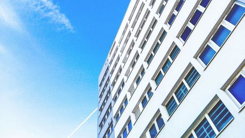 Low angle view of modern building against blue sky