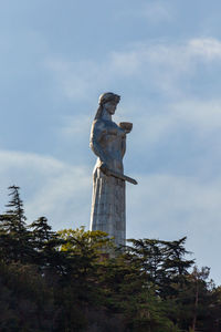 Low angle view of statue against sky