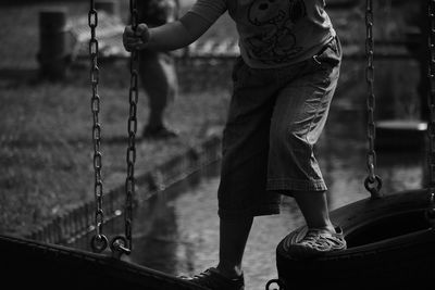 Close-up of woman standing on bench