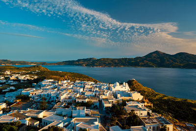 High angle view of townscape by sea against sky