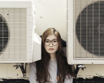 Portrait of woman amidst air ducts