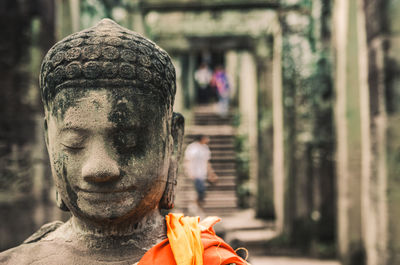 Stone statue of a seated buddha in a temple in cambodia. 