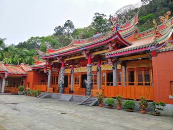 Temple by building against sky