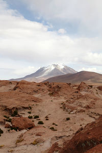 Scenic view of mountains against cloudy sky