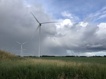 Windmill on field against sky