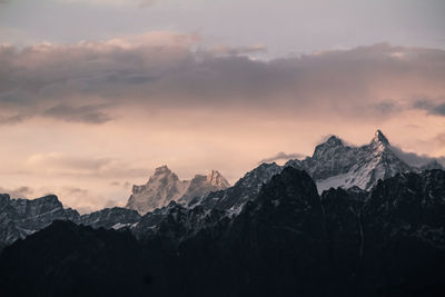 Scenic view of snowcapped mountains against sky during sunset