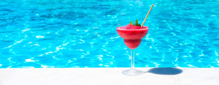 Close-up of drink in swimming pool