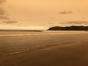 Scenic view of beach against sky during sunset