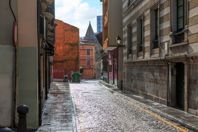 Narrow alley amidst buildings in city