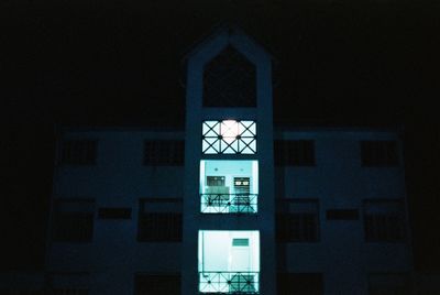 Low angle view of illuminated building against sky at night